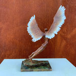 Figurative bronze sculpture of mythical Greek winged figure Icarus by Nicola Godden, displayed on plinth.
