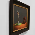 Silver golf trophy on green napkin in swing towards chocolate covered donut