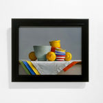 Lemons around light green bowl, stack of striped bowls, and small bowls