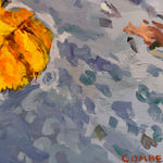 Reflection of city buildings in a puddle with fall leaves in it