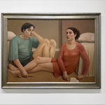 Man in a blue shirt and a woman in a red dress sitting on a bedroom floor