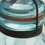 Oil painting of 4 clear glass vessels on white table cloth on linen