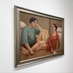 Man in a blue shirt and a woman in a red dress sitting on a bedroom floor