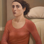 Man in a blue shirt and a woman in a red dress sitting on a bedroom floor