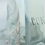 Oil painting of 4 clear glass vessels on white table cloth on linen