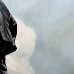 Man in business suit walking on a tightwire