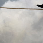 Man in business suit walking on a tightwire
