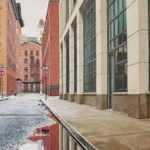 View from ground of puddle on Collister street reflecting grey sky