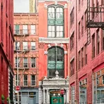 low viewpoint of a puddle on a narrow Tribeca Street