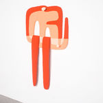 orange tufted rug in an irregular shape