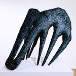 black sculpture resembling tongs