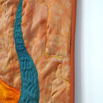 sewn tapestry hanging on wall