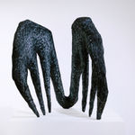 black sculpture resembling tongs