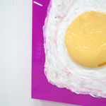 sculpture of a sunny side up egg on a pink canvas backdrop