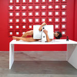 man on a desk hugging his computer