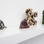 white shelf with assorted ceramic figures by Jocelyn Tsaih