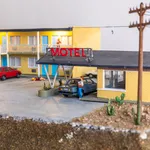 miniature diorama by Abigail Goldman of a woman bleeding on the ground in the parking lot of a motel