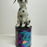 Mark Gagnon - sculptures of a black and white dog sitting and a can with the image of a dog head and the text "YA" next to it