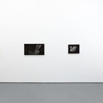 white gallery wall with four greyscale paintings by Angela Fang Zirbes