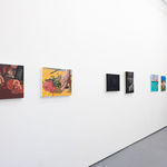 white gallery wall with paintings of various sizes