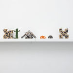 white shelf with assorted small figure statues by Jocelyn Tsaih