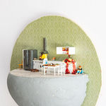 miniature diorama by Abigail Goldman of a woman cooking in her kitchen with severed body parts