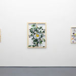 white wall with three paintings displayed