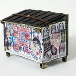 Drew Leshko miniature blue dumpster covered in wheatpaste
