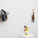 white wall with three different sculptures displayed