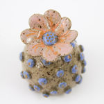 Jen Dwyer sculpture - round tan plant with blue dots all over and pink flower on top