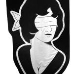 embroidered black and white banner of a blindfolded woman