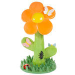 Lorien Stern's ceramic sculpture of an orange flower with grass and bugs