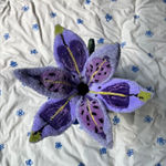 top of Shishi San sculpture - purple flower visible