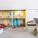 miniature diorama by Abigail Goldman of a woman bleeding on the ground in the parking lot of a motel