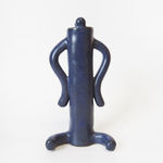 ceramic piece by Jocelyn Tsaih of a tall deep purple figure sitting