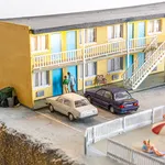 miniature diorama by Abigail Goldman of a woman bleeding on the ground in the parking lot of a motel
