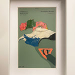 Painting on a green paint chip of a woman laying down in white frame