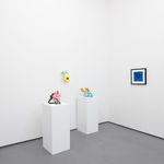 white gallery walls with small artworks and sculptures