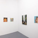 Whtie gallery walls with paintings of various sizes on the wslls