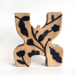 ceramic figure by Jocelyn Tsaih of a brown figure with black flowers on it