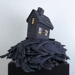 Tania Alvarez sculpture of house on bed of hands