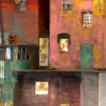 detail illuminated sculpture of buildings in a vertical formation