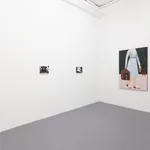 White gallery wall with paintings of various sizes by Angela Burson