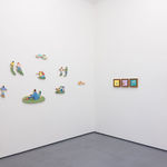 White gallery wall with various pieces by Danym Kwon including paintings and small wooden sculptures