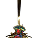 Sculpture of a brass crab with an underwater scene inside of the crab shell