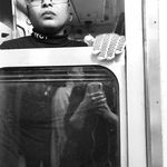 black and white photo of a subway train conductor looking out the window