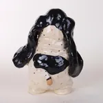 Katie Kimmel - ceramic sculpture of a black and white basset hound standing on its hind legs