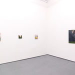 White gallery walls with paintings of various sizes by Angela Burson