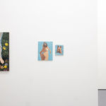 white gallery wall with paintings of various sizes