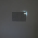 An image of the piece with a small burst of light showing sea shells in the right corner of piece.